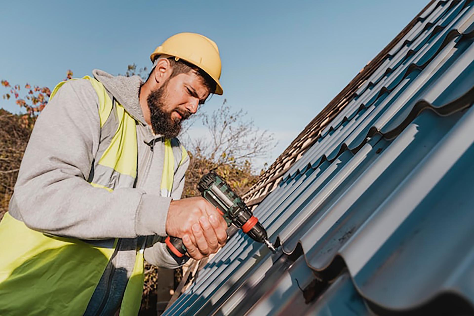 sideways-man-working-roof-with-drill_23-2148748771