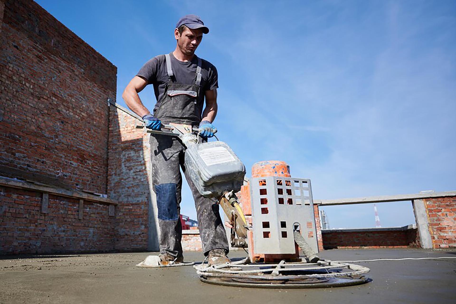 worker-using-power-trowel-machine-construction-site_651396-3214